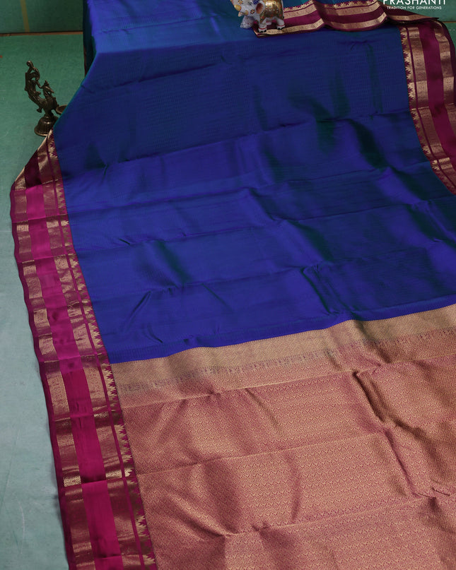 Pure kanchipuram silk saree dual tone bluish green and dark magenta with allover self emboss pattern and rettapet zari woven border