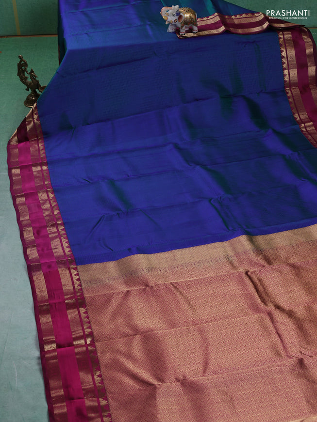 Pure kanchipuram silk saree dual tone bluish green and dark magenta with allover self emboss pattern and rettapet zari woven border