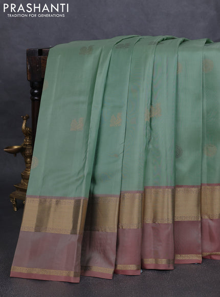 Pure kanchipuram silk saree pastel green and pastel peach with zari woven buttas and rettapet zari woven border