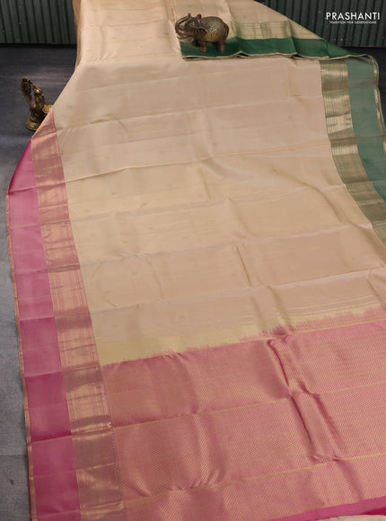 Pure kanchipuram silk saree cream and dual tone pink with zari woven buttas and ganga jamuna border