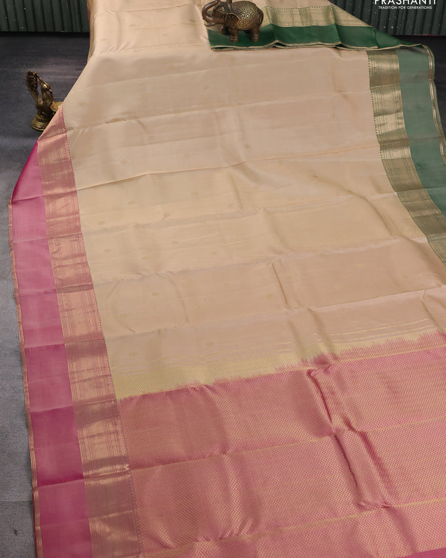 Pure kanchipuram silk saree cream and dual tone pink with zari woven buttas and ganga jamuna border