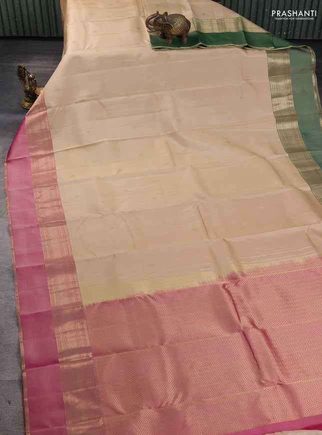 Pure kanchipuram silk saree cream and dual tone pink with zari woven buttas and ganga jamuna border