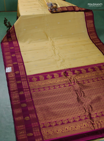 Pure gadwal silk saree pale yellow and purple with silver zari woven buttas and rettapet zari woven border