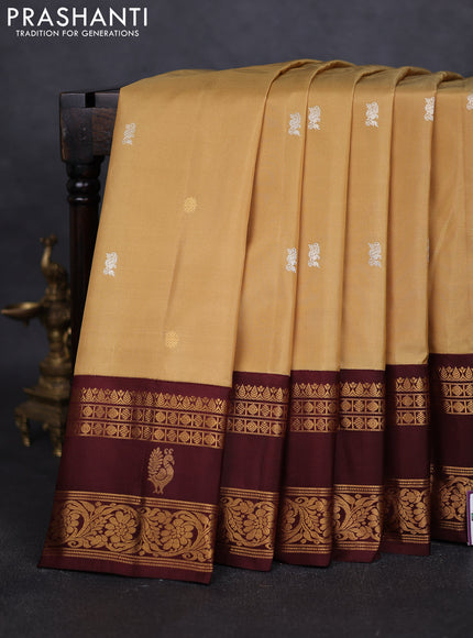 Pure gadwal silk saree sandal and deep maroon with silver & gold zari woven buttas and rettapet zari woven border