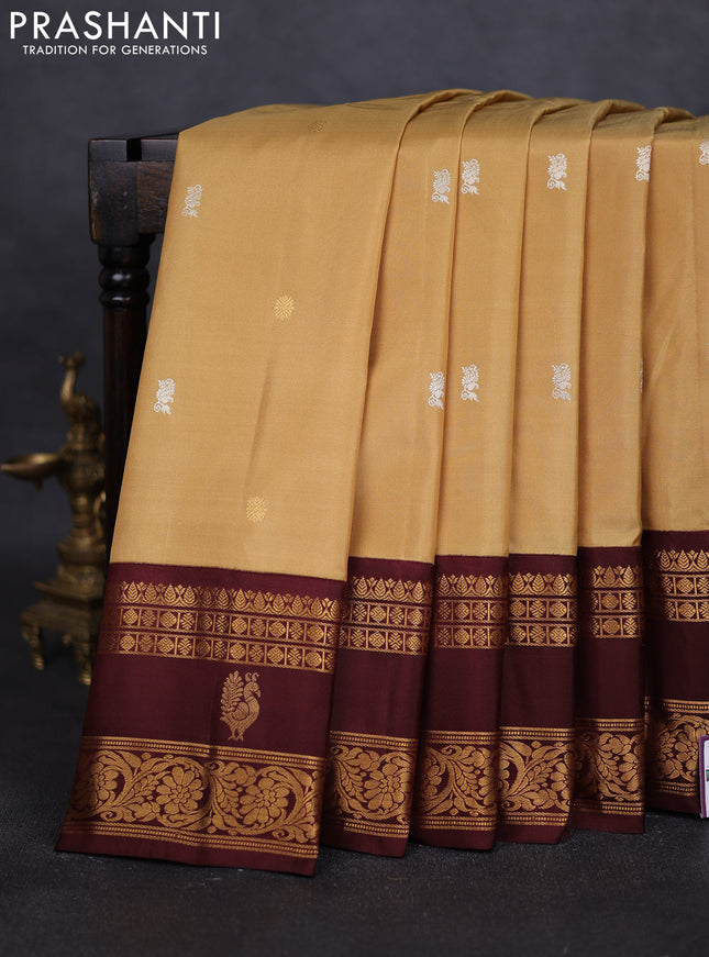 Pure gadwal silk saree sandal and deep maroon with silver & gold zari woven buttas and rettapet zari woven border