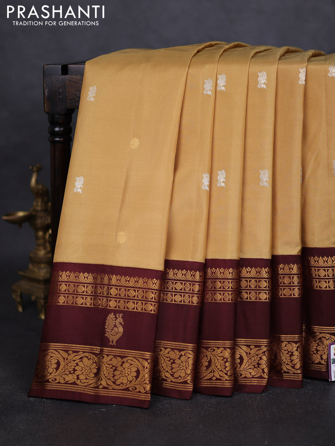 Pure gadwal silk saree sandal and deep maroon with silver & gold zari woven buttas and rettapet zari woven border