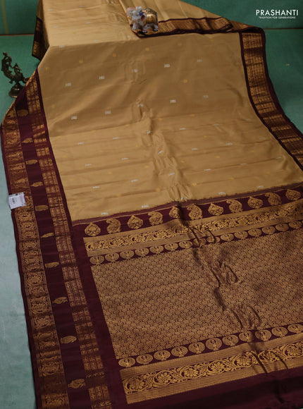 Pure gadwal silk saree sandal and deep maroon with silver & gold zari woven buttas and rettapet zari woven border