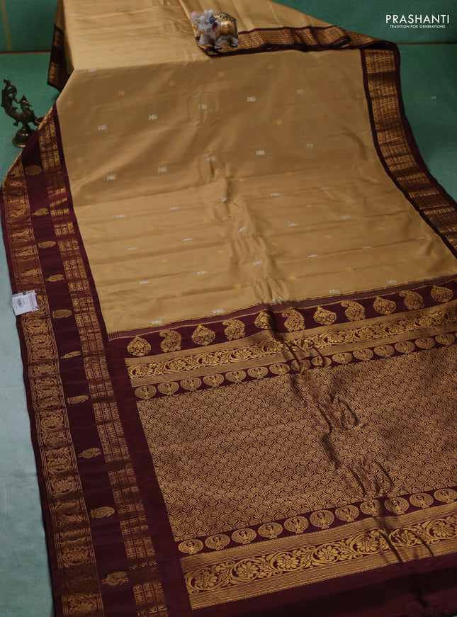 Pure gadwal silk saree sandal and deep maroon with silver & gold zari woven buttas and rettapet zari woven border