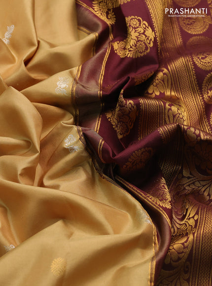 Pure gadwal silk saree sandal and deep maroon with silver & gold zari woven buttas and rettapet zari woven border