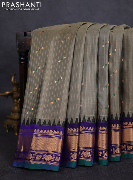 Pure gadwal silk saree greyish green and blue with allover zari weaves & buttas and zari woven border