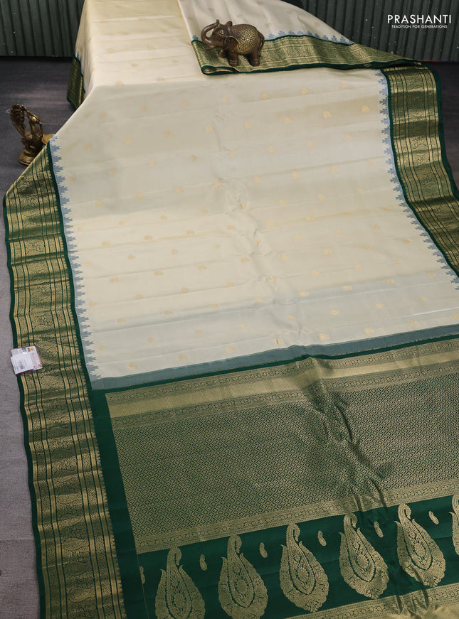 Pure gadwal silk saree off white and green with paisley zari woven buttas and temple design zari woven border