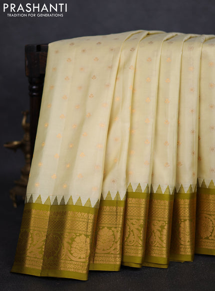 Pure gadwal silk saree cream and mehendi green with zari woven buttas and temple design zari woven border