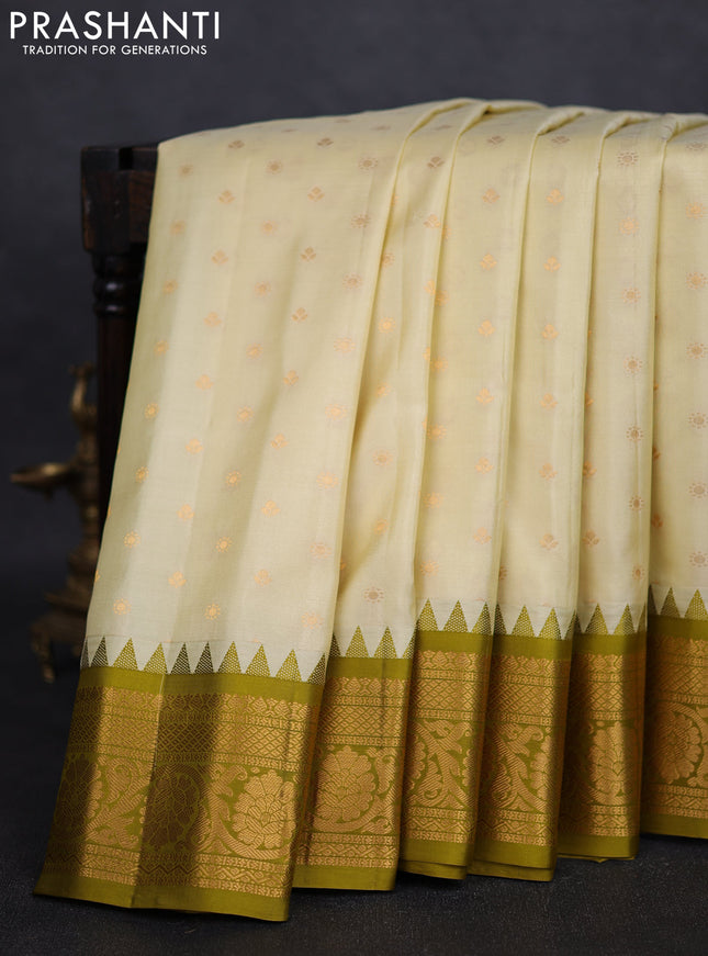 Pure gadwal silk saree cream and mehendi green with zari woven buttas and temple design zari woven border