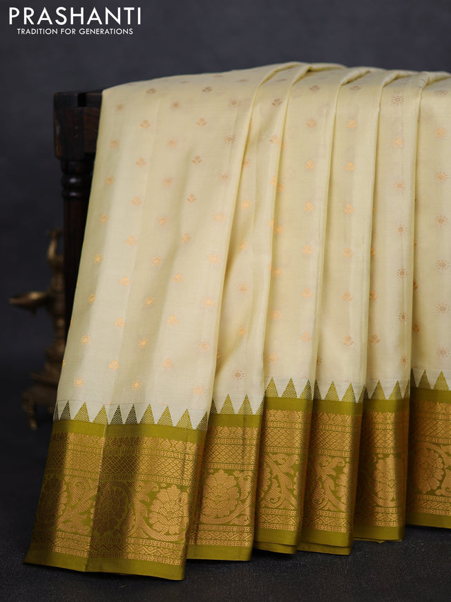 Pure gadwal silk saree cream and mehendi green with zari woven buttas and temple design zari woven border