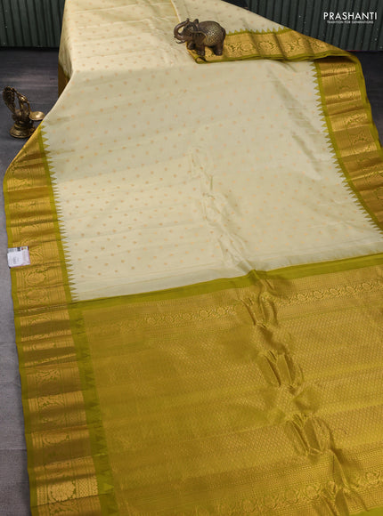 Pure gadwal silk saree cream and mehendi green with zari woven buttas and temple design zari woven border