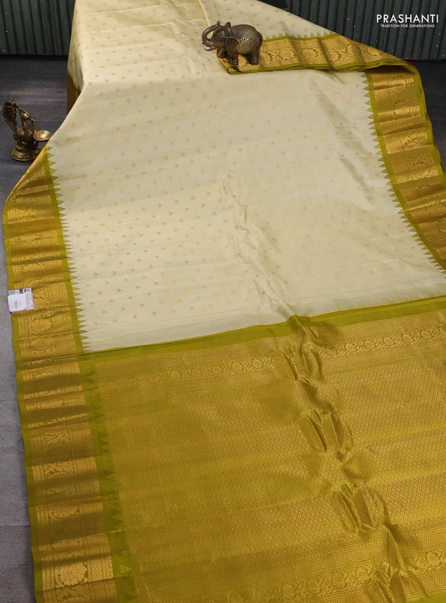 Pure gadwal silk saree cream and mehendi green with zari woven buttas and temple design zari woven border