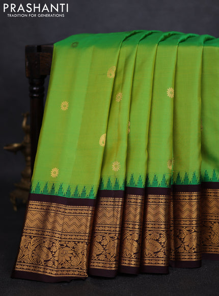 Pure gadwal silk saree light green and deep coffee brown with zari woven buttas and temple design zari woven border