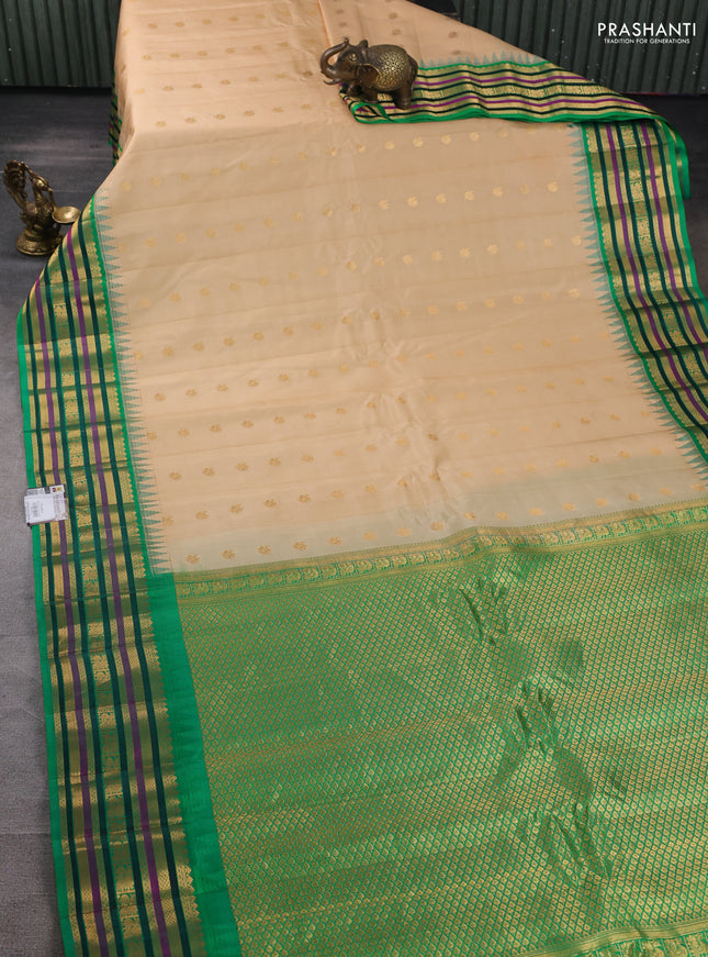 Pure gadwal silk saree beige and green with annam zari woven buttas and temple design zari woven border