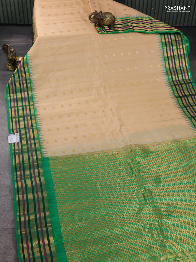 Pure gadwal silk saree beige and green with annam zari woven buttas and temple design zari woven border