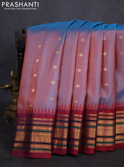 Pure gadwal silk saree dual shade of rust and dual shade of maroon with allover zari woven buttas and temple design zari woven border
