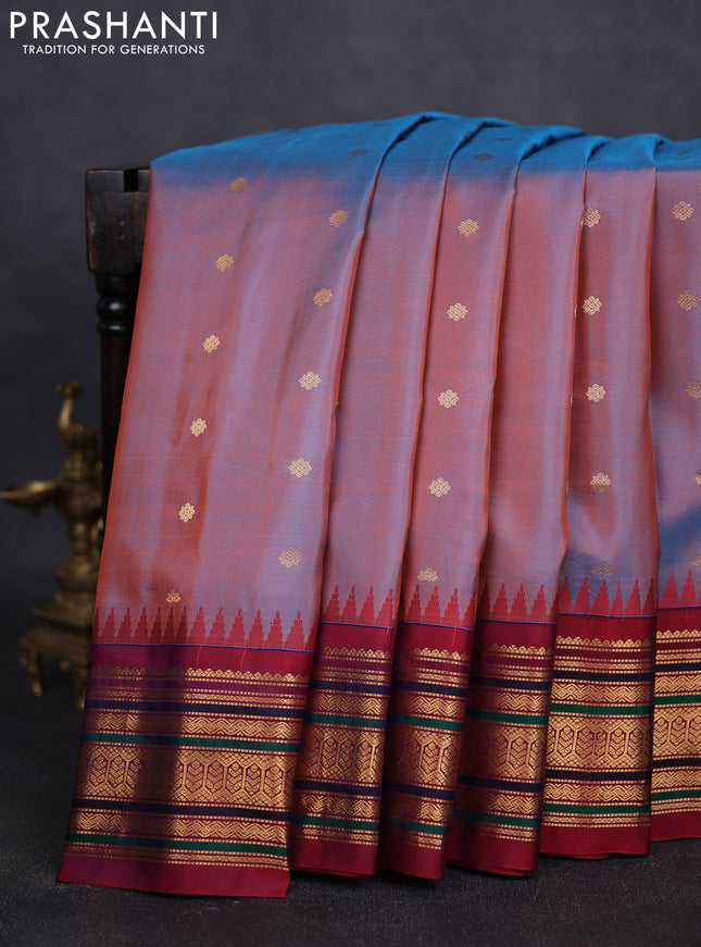 Pure gadwal silk saree dual shade of rust and dual shade of maroon with allover zari woven buttas and temple design zari woven border