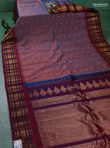 Pure gadwal silk saree dual shade of rust and dual shade of maroon with allover zari woven buttas and temple design zari woven border