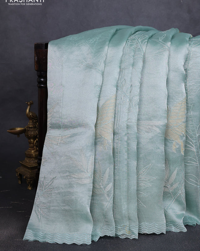 Tissue silk saree teal green with allover pita embroidery work and simple embroidery border