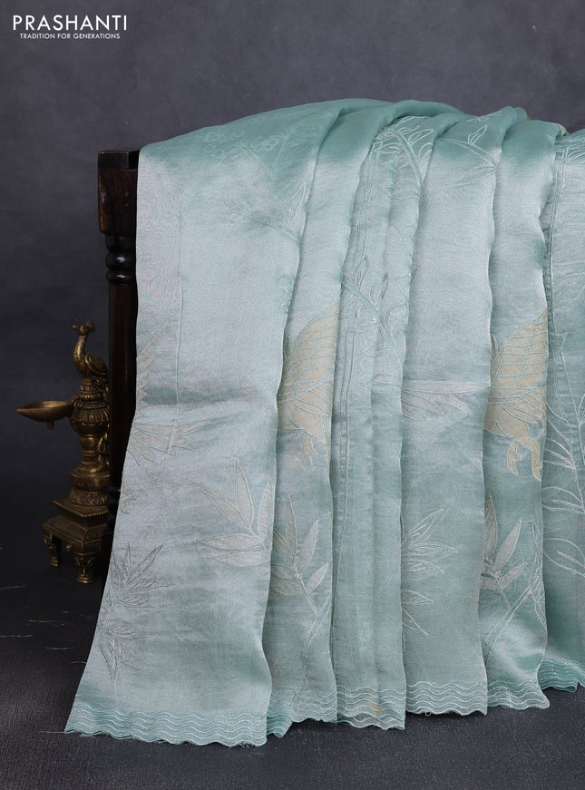 Tissue silk saree teal green with allover pita embroidery work and simple embroidery border