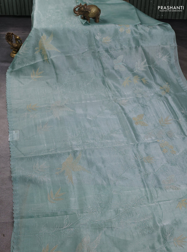 Tissue silk saree teal green with allover pita embroidery work and simple embroidery border