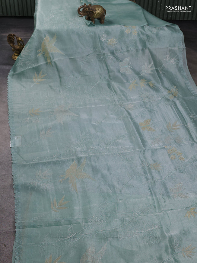 Tissue silk saree teal green with allover pita embroidery work and simple embroidery border