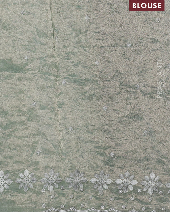 Tissue silk saree pastel green with allover embroidery & sequin work and beaded work border