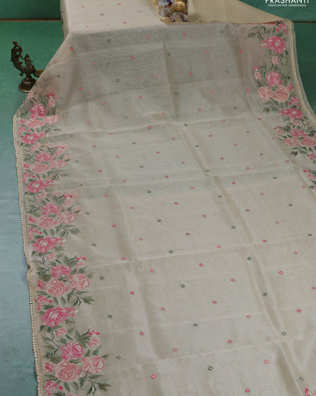 Chander tissue saree cream with embroidery work and floral embroidery border