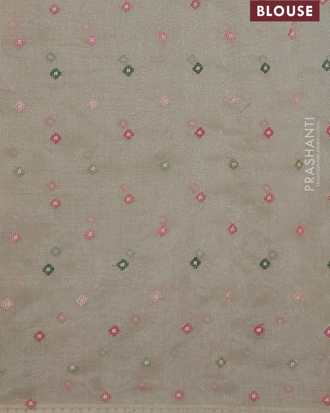 Chander tissue saree cream with embroidery work and floral embroidery border