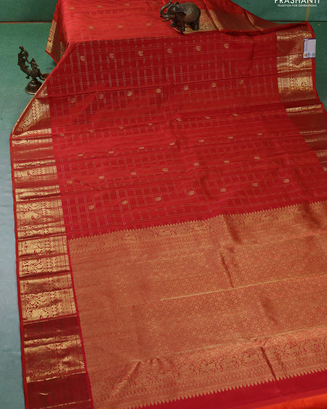 Pure kanchipuram silk saree orange with allover zari checks & buttas and zari woven border