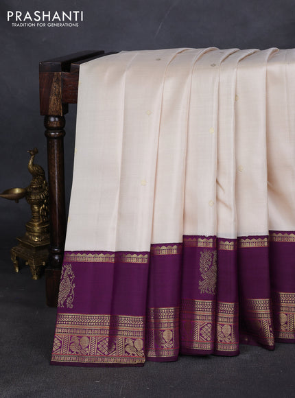 Pure kanchipuram silk saree cream and purple with zari woven buttas and long rich zari woven korvai border