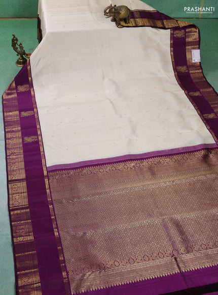 Pure kanchipuram silk saree cream and purple with zari woven buttas and long rich zari woven korvai border