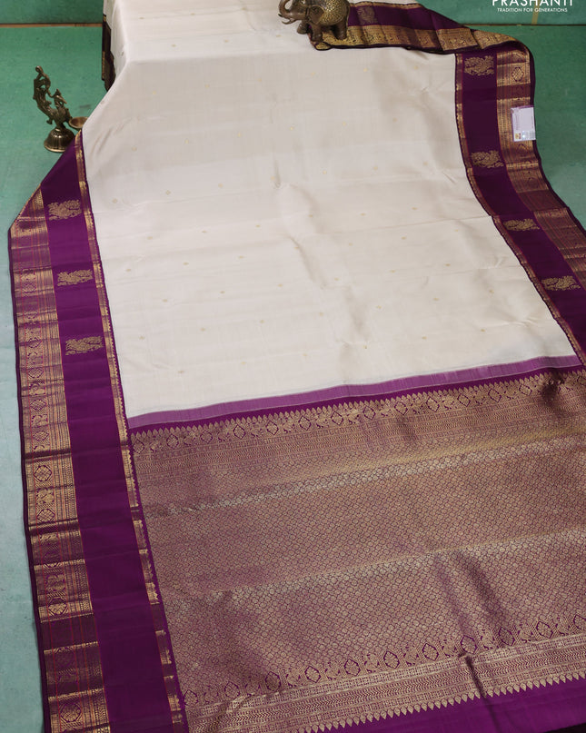 Pure kanchipuram silk saree cream and purple with zari woven buttas and long rich zari woven korvai border