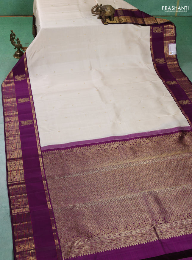 Pure kanchipuram silk saree cream and purple with zari woven buttas and long rich zari woven korvai border