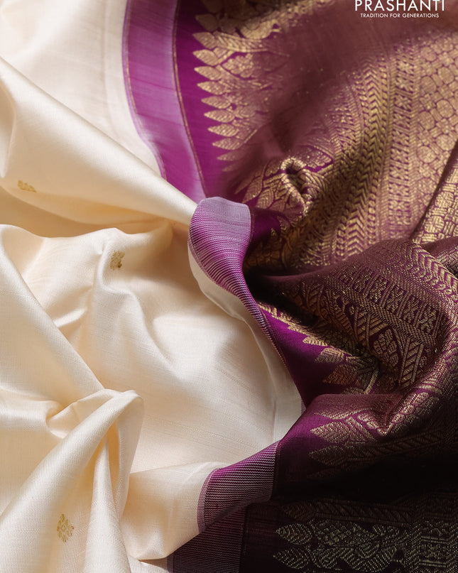 Pure kanchipuram silk saree cream and purple with zari woven buttas and long rich zari woven korvai border