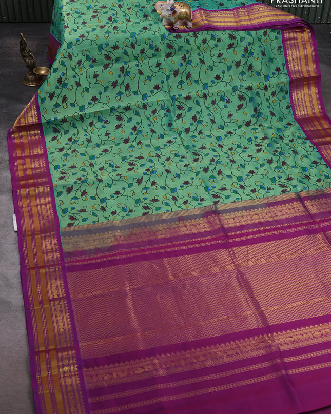 Silk cotton saree teal green and purple with allover kalamakri prints and zari woven korvai border