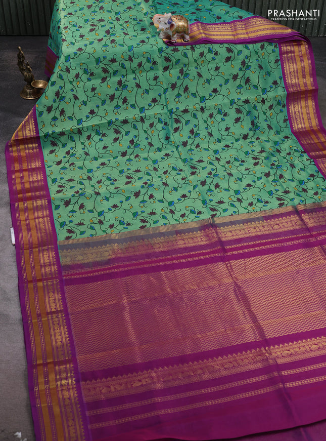 Silk cotton saree teal green and purple with allover kalamakri prints and zari woven korvai border