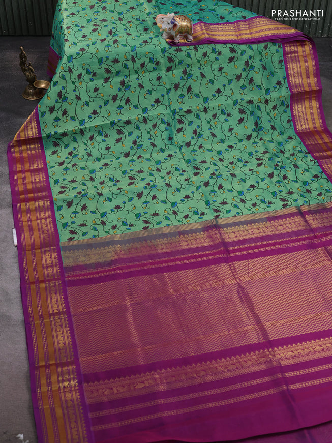 Silk cotton saree teal green and purple with allover kalamakri prints and zari woven korvai border