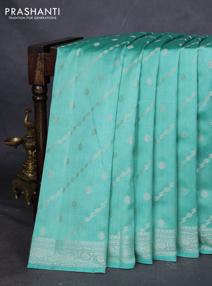 Chiniya silk saree teal green shade with allover silver zari weaves and zari woven border