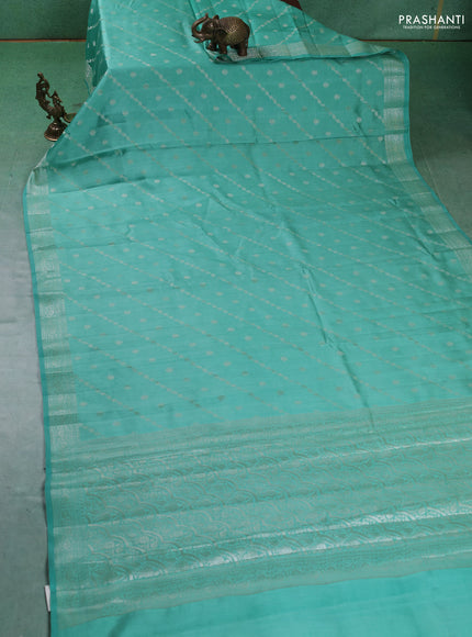 Chiniya silk saree teal green shade with allover silver zari weaves and zari woven border