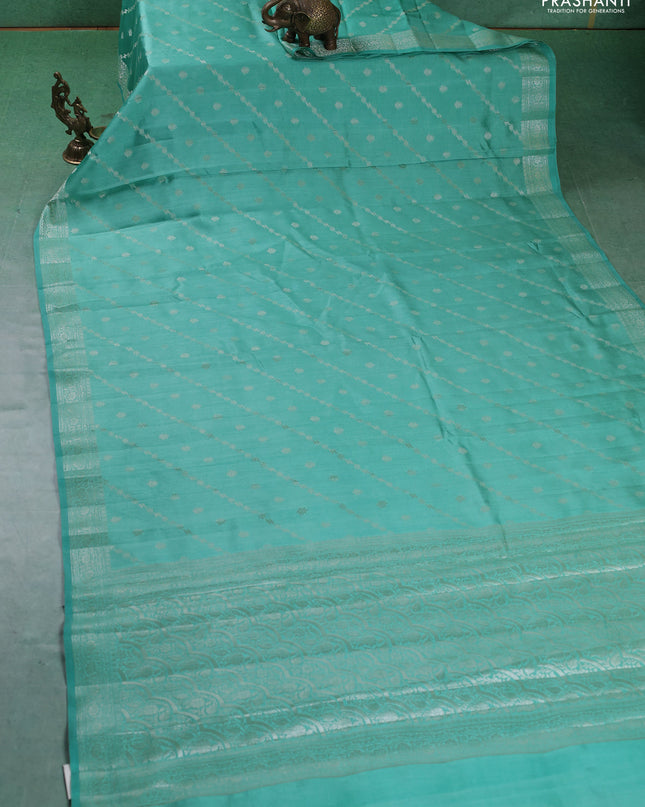 Chiniya silk saree teal green shade with allover silver zari weaves and zari woven border