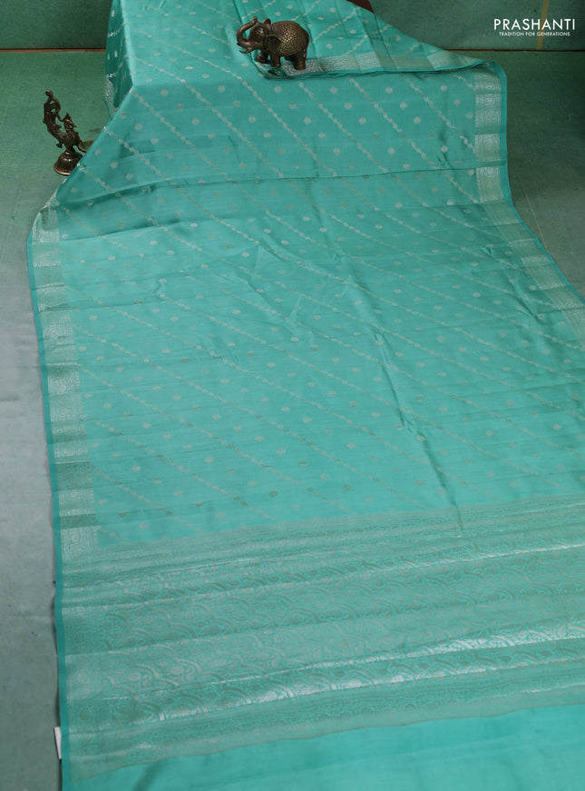 Chiniya silk saree teal green shade with allover silver zari weaves and zari woven border