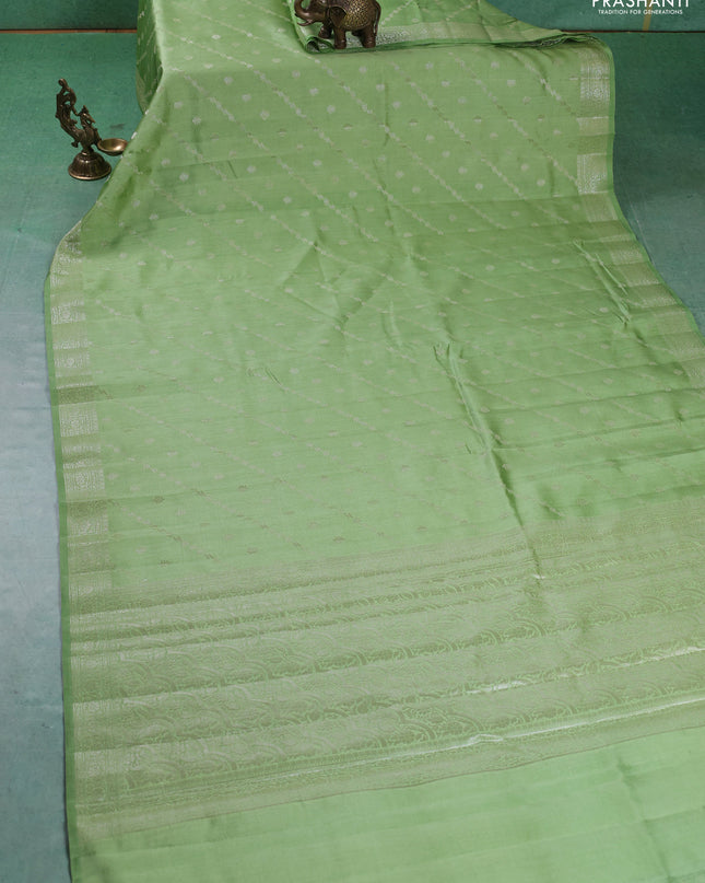 Chiniya silk saree pastel green with allover silver zari weaves and zari woven border