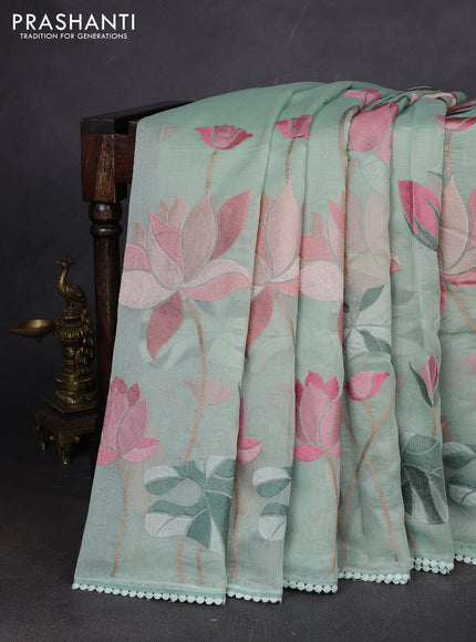 Art tissue chanderi saree pastel green with allover floral embroidery and lace work border