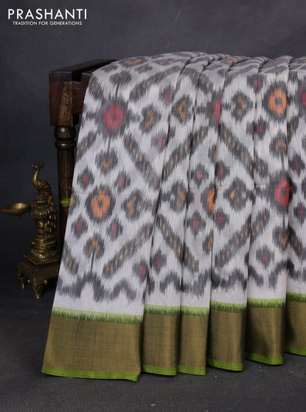 Ikat silk cotton saree off white and green with allover ikat weaves and zari woven border