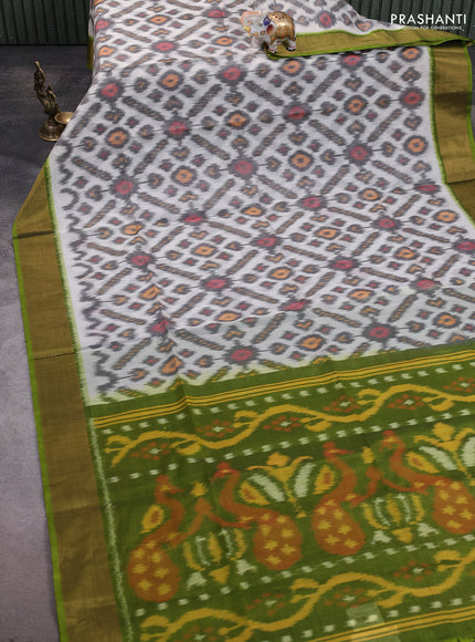 Ikat silk cotton saree off white and green with allover ikat weaves and zari woven border